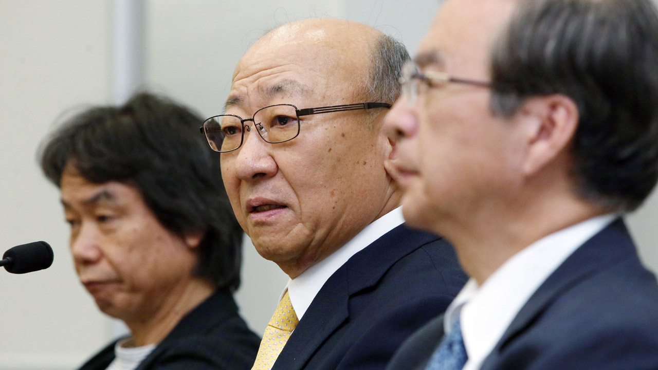 Tatsumi Kimishima(C), newly appointed president of Japanese videogame giant Nintendo speaks to reporters at the Osaka Stock Exchange in Osaka on September 14, 2015, while Nintendo's famous game creator Shigeru Miyamoto (L) looks on. Nintendo said it has appointed Kimishima as its new president two months after its chief executive Satoru Iwata died from cancer. AFP PHOTO / JIJI PRESS JAPAN OUT (Photo credit should read JIJI PRESS/AFP/Getty Images)